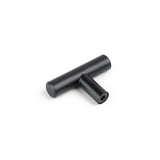 Le bouton noir Remo de yessential.fr est une poignée en métal noir en forme de T avec un trou de vis hexagonal, illustré sur fond blanc. Idéal comme accent noir mat pour les armoires ou tiroirs modernes.
