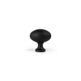 Doté d'une forme de champignon noir mat avec un sommet arrondi et une tige courte et large, l'Agero Black Knob Deluxe de yessential.fr est centré sur un fond blanc uni.