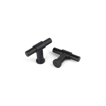 Deux boutons Cordero Black de yessential.fr avec une finition noire mate sont présentés sur une surface blanche : l'un tient debout, l'autre repose à plat pour que la base ronde soit visible.