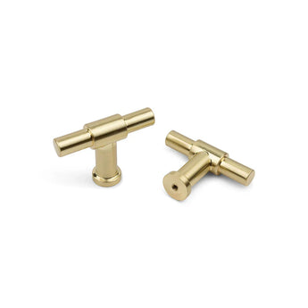 Deux boutons d'armoire modernes et cylindriques Cordero Gold de yessential.fr sont affichés sur un fond blanc ; l'un se tient debout tandis que l'autre est couché sur le côté.