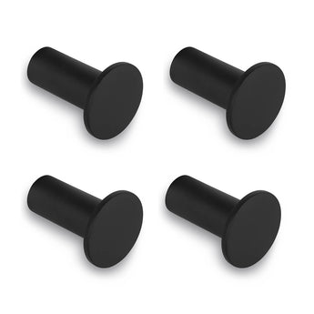 Quatre crochets muraux Carreno Black de yessential.fr sont présentés dans un carré sur fond blanc. Chaque crochet a une façade plate et arrondie et une base cylindrique – idéal comme accessoire de salle de bain élégant. L'ensemble comprend 4 crochets noirs en acier inoxydable.