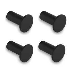 Quatre crochets muraux Carreno Black de yessential.fr sont présentés dans un carré sur fond blanc. Chaque crochet a une façade plate et arrondie et une base cylindrique – idéal comme accessoire de salle de bain élégant. L'ensemble comprend 4 crochets noirs en acier inoxydable.