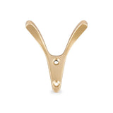 Le Vilano Gold de yessential.fr est une patère dorée avec un design en forme de Y et deux trous de montage, représenté sur un fond blanc.