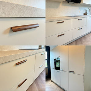 Cuisine moderne de yessential.fr avec poignées en noyer Lucasso, armoires blanc mat, plans de travail en pierre naturelle, électroménagers encastrés et un design minimaliste épuré avec un décor naturel et beaucoup de lumière. Montré sous plusieurs angles.