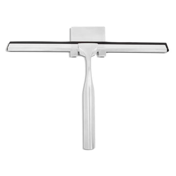 La Zamoro Stainless Steel de yessential.fr est une raclette de douche en acier inoxydable de couleur argentée avec une lame en caoutchouc noir et un support 3M assorti, présentée sur fond blanc.