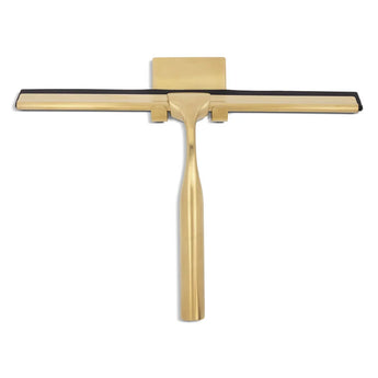 La Zamoro Gold de yessential.fr est une raclette de douche en acier inoxydable de couleur dorée dotée d'une lame en caoutchouc noir, affichée sur fond blanc.