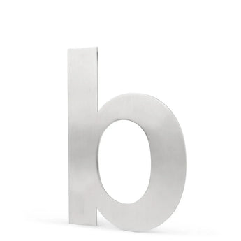 L'Adamo Stainless Steel 15cm de yessential.fr est un b minuscule métallique avec une finition argent brossé, inspiré des numéros de maison élégants, et se tient debout sur un fond blanc.