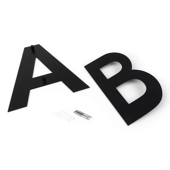 Deux grandes lettres plates Adamo Black 15 cm A et B de yessential.fr reposent sur une surface blanche avec des vis et des chevilles de fixation murale - parfaites comme numéro de maison élégant en acier inoxydable noir pour votre maison.