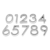 Les numéros adhésifs Silvio Chrome 60 mm de yessential.fr sont disposés en trois rangées soignées sur un fond blanc, avec les chiffres de 0 à 9 dans l'ordre.