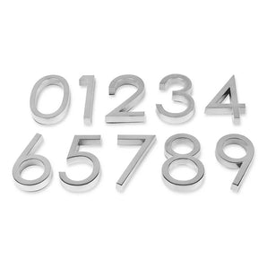 Les numéros adhésifs Silvio Chrome 60 mm de yessential.fr sont disposés en trois rangées soignées sur un fond blanc, avec les chiffres de 0 à 9 dans l'ordre.