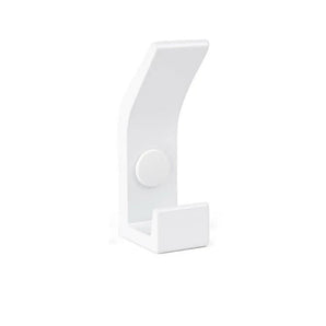 La patère Huso White de yessential.fr présente un design blanc minimaliste avec une base rectangulaire, une courbe douce et un point de fixation rond central, sur un fond blanc uni.