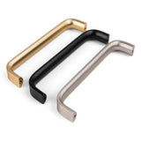 Trois poignées Leonardo Stainless Steel Deluxe de yessential.fr en or, noir et argent sont placées en diagonale sur un fond blanc. Ces poignées modernes ont un design rectangulaire avec des coins arrondis pour un look luxueux.
