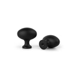 Deux Agero Black Knob Deluxe de yessential.fr sont représentés sur un fond blanc : l'un est vertical, l'autre est sur le côté avec un trou dans la base plate. Les deux boutons ont un design noir mat en forme de champignon.