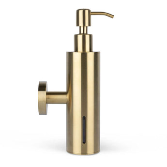 L'Alberto Gold de yessential.fr est un distributeur de savon cylindrique en or brossé, avec un support mural sur le côté gauche, un dessus de pompe et une fenêtre verticale pour indiquer le niveau de savon.