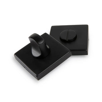 Deux serrures de WC Vano Black de yessential.fr - avec un bouton rotatif et une fente pour une clé plate - ont une finition noire mate élégante, toutes deux présentées sur un fond blanc.