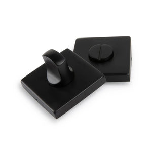 Deux serrures de WC Vano Black de yessential.fr - avec un bouton rotatif et une fente pour une clé plate - ont une finition noire mate élégante, toutes deux présentées sur un fond blanc.