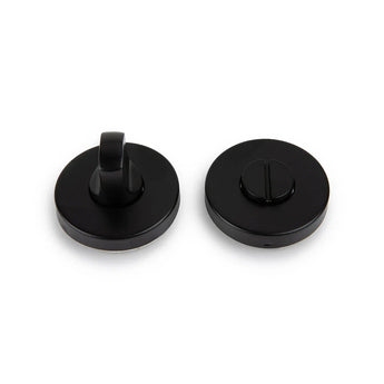 Deux serrures WC rondes en métal noir Rodi Black de yessential.fr - une avec un bouton rotatif, une avec une fente plate - sont représentées sur un fond blanc. Parfait comme serrure de toilette noire mate élégante pour votre porte.