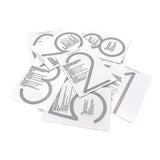Une pile dispersée de feuilles d'instructions blanches Amato Black de 15 cm de yessential.fr, chacune avec un grand chiffre gris et un texte imprimé - avec des numéros de maison modernes comme 1, 2, 3 et 8.